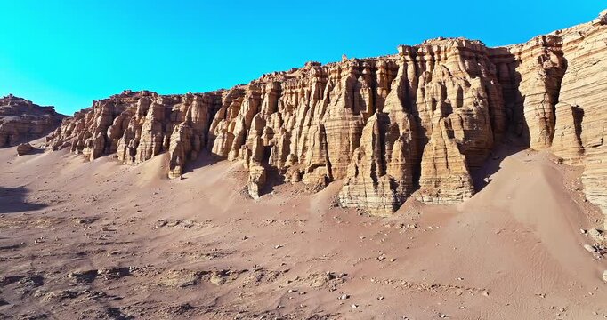 Scenic view of rugged Yardang geological formations and wind-eroded rocks in the Gobi Desert, Xinjiang, China.