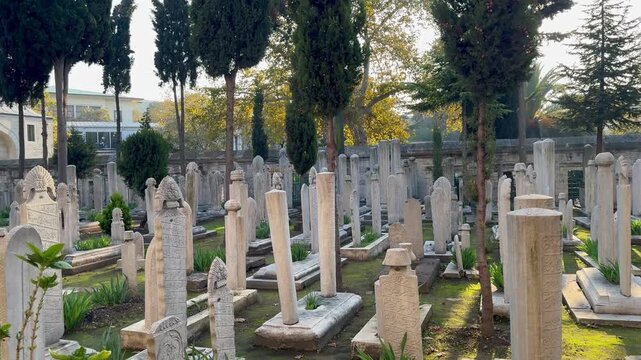 The sacred necropolis of Suleymaniye Mosque in Istanbul, burial site of Sultan Suleiman the Magnificent and Hurrem Sultan. Historic Ottoman cemetery with ancient marble tombstones and cypresses.