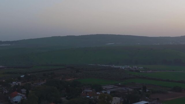 Kafr Misr village in Israel overlooks the natural beauty of the Wadi Nahal Kama valley at sunset.
