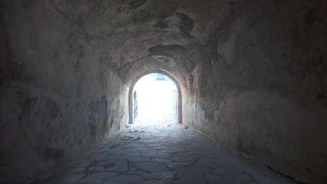 Ancient vomitorium entrance at Pompeii's amphitheatre shows classic Roman arched corridor leading spectators into preserved 1st-century BC structure