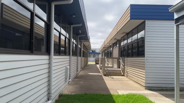 Modest classroom buildings at a public primary school campus in Australia. Basic school architecture reflecting practical and functional educational infrastructure in a suburban community.