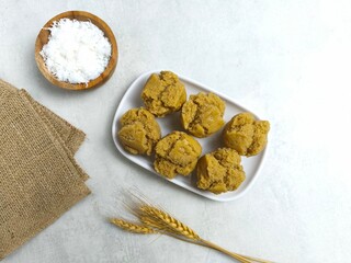 Traditional Indonesian Apem Cake With Palm Sugar and Grated Coconut in White Plate