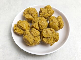 Traditional Indonesian Apem Cake With Palm Sugar and Grated Coconut in White Plate