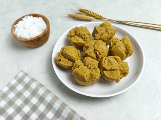 Traditional Indonesian Apem Cake With Palm Sugar and Grated Coconut in White Plate