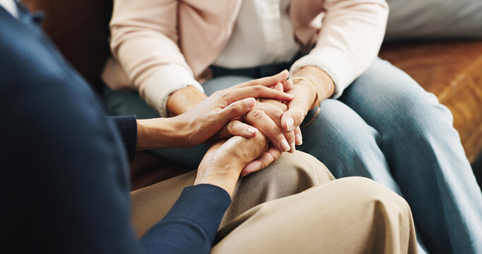 Care, friends and holding hands on sofa in home for emotional support, grief and comfort. Trust, understanding and console person with depression in living room for mourning, compassion and sympathy