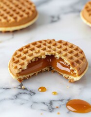 Delicious caramel-filled waffle cookies on a marble surface