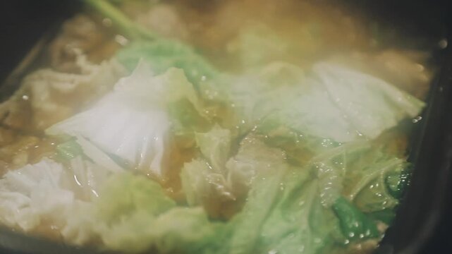 Shabu Shabu or Sukiyaki or hot pot ,Hand holding pork using chopsticks, Japanese food in restaurant