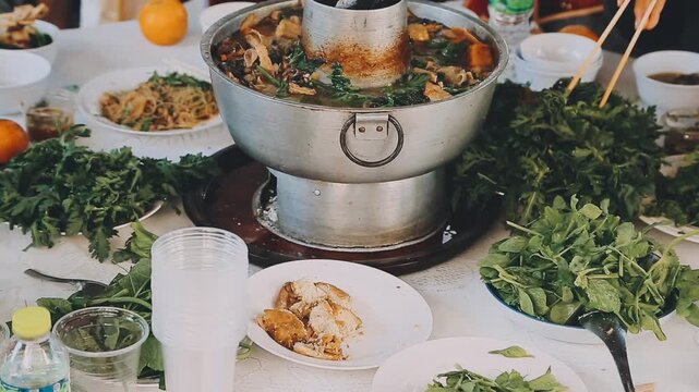 Shabu Shabu or Sukiyaki or hot pot ,Hand holding pork using chopsticks, Japanese food in restaurant