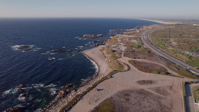 Atlantic rocky coastline running parallel to EN120 coastal road near Miradouro da Costa Norte inside Parque Natural do Sudoeste Alentejano e Costa Vicentina, Sines, Set&uacute;bal District, Alentejo Portugal