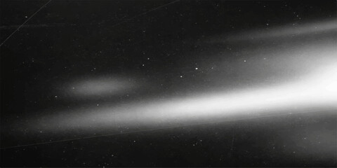 A vast nebula of bright stars and dark clouds glows across the starry night sky of a deep blue galaxy in the infinite outer space cosmos © suriyaakter