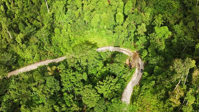 Top-down drone view of a car on mountain road after typhoon in Palawan