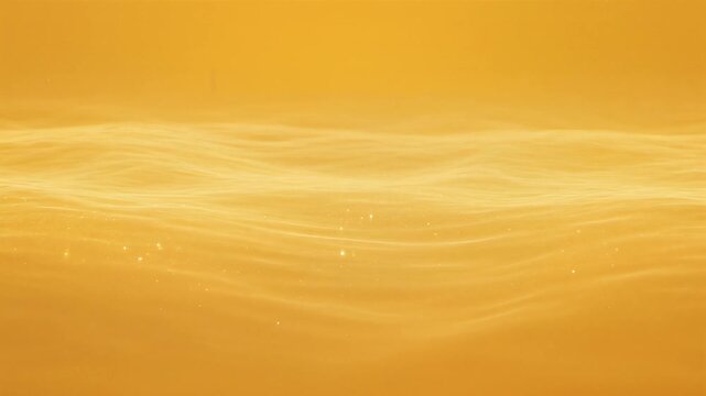 Golden flowing waves of light on a smooth surface in warm tones, abstract and serene.