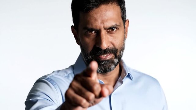 Man pointing assertively with serious expression