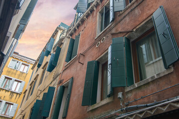Venetian facade with open green shutters © Sergey