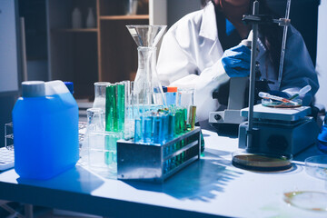 Fototapeta premium Science, laboratory and woman with pipette, test tube and biotech solution in research. Medical innovation, scientist or lab technician in study for healthcare, medicine and vaccine results feedback.