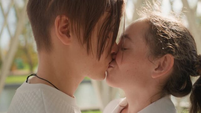 Closeup kiss sequence in gazebo, candid intimate marriage moment with soft backlight, lips meeting and gentle hands, faces framed by lattice and sunlit hair, playful smile and tearful joy