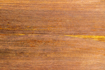 Tekstura drewna w ciepłych brązach, deska z widocznym usłojeniem i delikatnymi przebarwieniami, naturalne tło do projektów. © Henryk Guziak