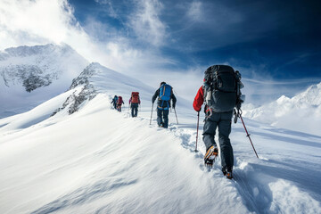 Obraz premium A group of mountaineers ascends a snow-covered slope, their colorful gear contrasting against the stark white landscape and blue sky
