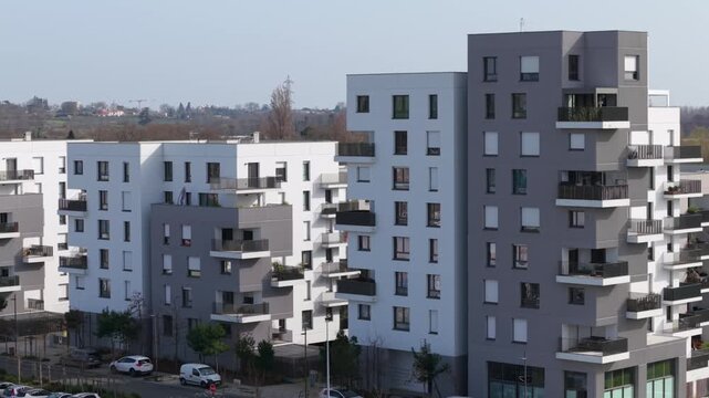 Beautiful aerial overview of large apartment buildings in a new suburban neighborhood in Eysines, Gironde, France on a sunny day.. High quality 4k footage