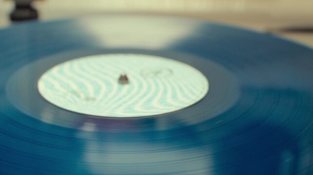 Close up of vitage record finishing and a hand retiring the needle