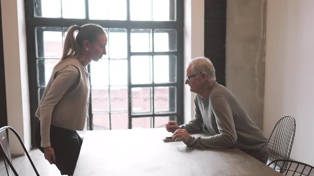 Business meeting of two professional in office company, old man and adult woman. People greeting and shaking hands, business etiquette and politeness job interview in international corporation