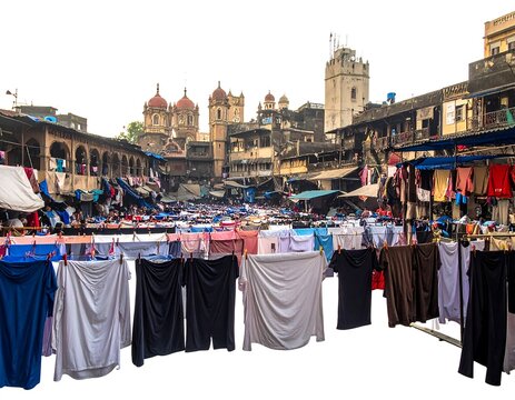 Clotheslines stretch over a dense outdoor market; a building with domes stands tall in the background