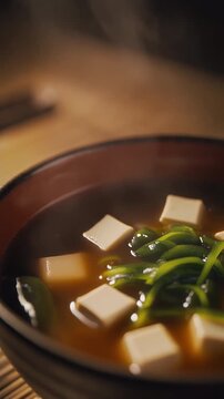 Steaming Traditional Miso Soup Macro Closeup on Rustic Wooden Tabletop in Minimalist Japanese Kitchen