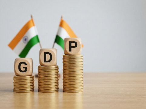 wooden cubes spelling gdp on ascending gold coin stacks with indian flags representing economic growth taxation and india financial development campaign concept