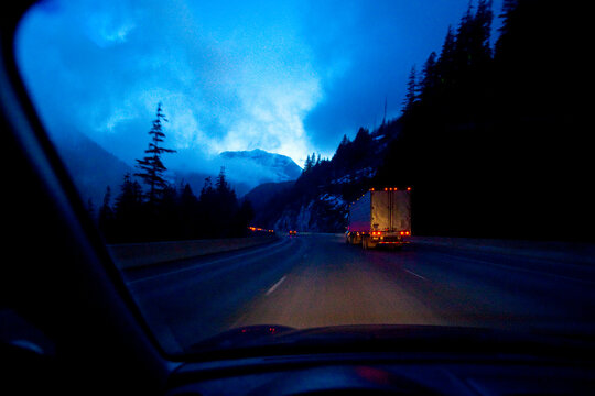Night highway driving on Snoqualmie Pass, a moonlight sky with clouds, driver's point of view.