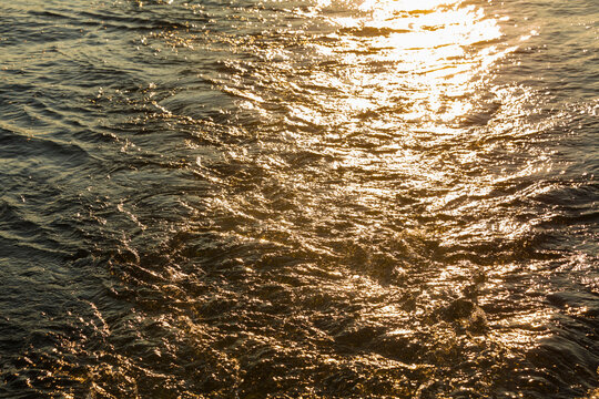 Churned up water with the sun reflecting off the surface.