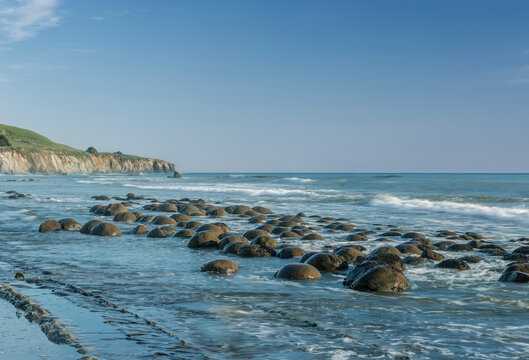 Mendocino County, Schooner Gulch State Beach, Bowling Ball Beach, boulders on the sand, waves on the shore.
