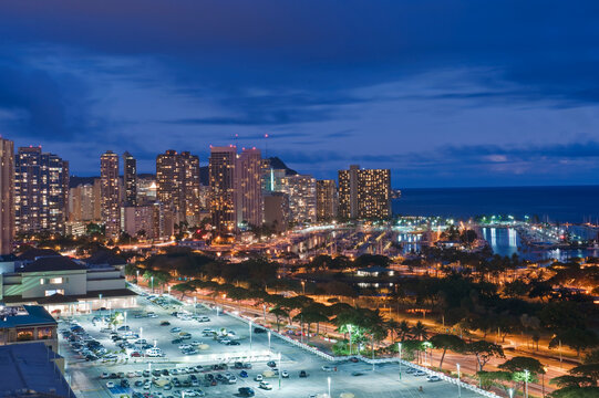 Honolulu, Waikiki, an elevated view of the downtown area and the waterfront at night.