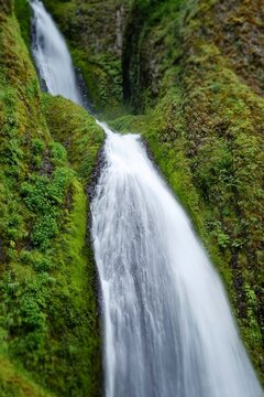 Lush green cliffs cradle the cascading waters of Wahkeena Falls in the Columbia River Gorge