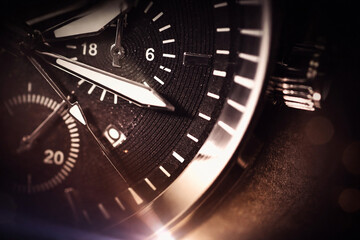 Fototapeta premium Macro close-up of luxury analog watch dial with chronograph details, dramatic warm bokeh and dark copy space—premium time management, business, fashion accessory concept for ads and branding.