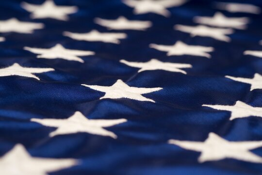 Close-up view of white embroidered stars on the blue field of the American flag