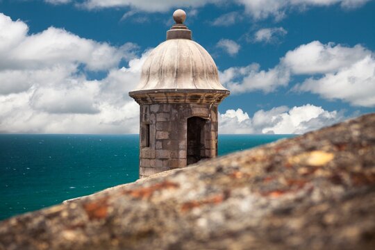 A historic sentry box at Castillo San Felipe del Morro in San Juan, Puerto Rico, stands watch over the turquoise waters of the Caribbean Sea