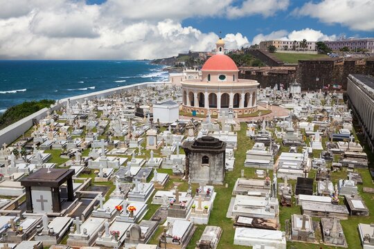 Cementerio de Santa Maria Magdalena de Pazzis rests beside the Atlantic Ocean in Old San Juan, Puerto Rico - a historic cemetery known for its neoclassical chapel with red dome and oceanfront setting.