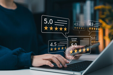 Fototapeta premium Customer satisfaction and online review rating concept. User typing on laptop giving five star feedback with rating showing customer reviews, reputation score, quality service and trust in business.