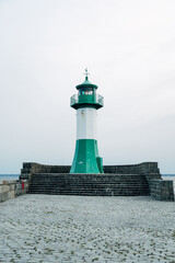 Fototapeta premium Iconic Lighthouse Standing on a Rugged Coastline, Maritime Sentinel Overlooking the Ocean in Bright Natural Daylight