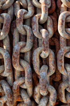 Detailed view of an old, rusted chain at Charleston Marina, Oregon, highlighting texture and weathered metal.