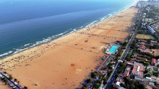 Recent aerial video of Marina Beach stretches endlessly with golden sands meet the deep blue Bay of Bengal as Chennai&rsquo;s skyline and metro corridor trace the vibrant coastline with kamarajar salai.