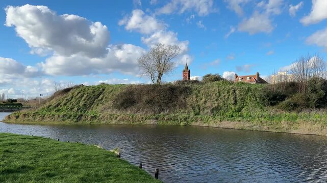 Riverside Embankment and Church Spire in Gosport Under Blue Sky