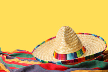 Fototapeta premium Cinco de Mayo, A sombrero awaits on colorful fabric