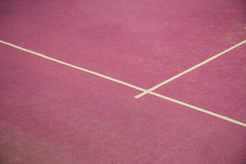 Fototapeta premium Padel court shows pink surface with white lines for play