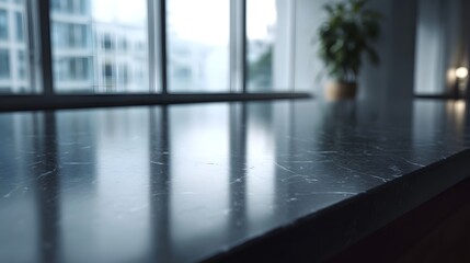 Fototapeta premium Polished dark marble countertop surface in a modern interior reflecting natural light from large