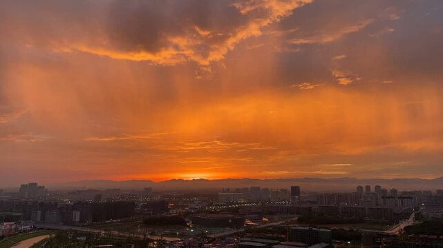 Cinematic Urban Sunset with Dramatic Sunbeams and Clouds - 4K Cityscape