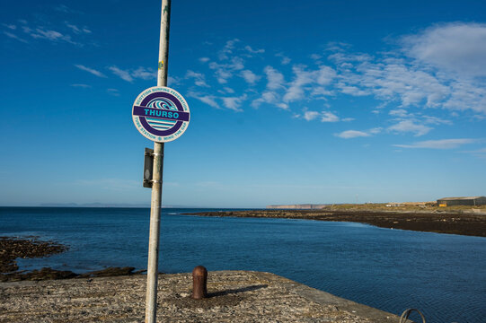 The harbour entrance to Thurso.  An old castle wall along the shore of the North Sea.  The town of Thurso, on the north coast of Scotland, along the North Sea.  Thurso Scotland, UK.