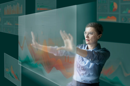 Businesswoman analyzing data on futuristic digital interface in office