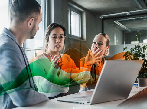Business team in discussion using digital technology at modern office
