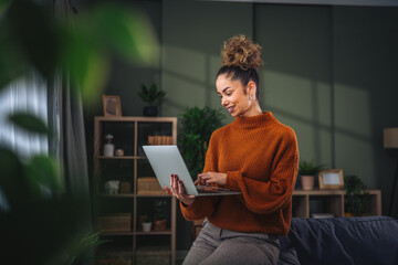 Young woman working remotely with laptop at home